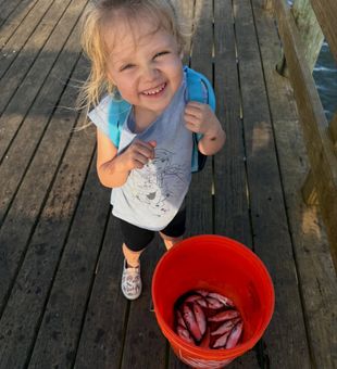 Happy kids fishing haul on Florida pier