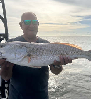 Trolling for redfish under clear skies at PaddleTail Waterfront Lodge!