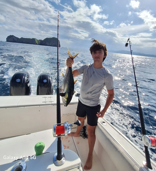 Proud angler with a fresh Yellowfin Tuna catch off Playa Flamingo!