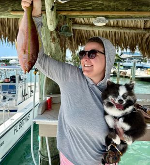 Cheerful catch! Lane Snapper and smiles dockside!