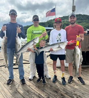 Family Beaver Lake Striped Bass catch with big smiles!