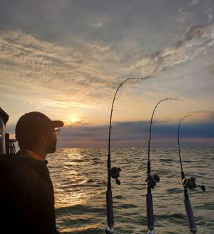 Golden offshore fishing sunrise lines set tight