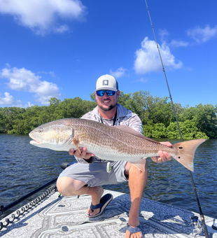 Huge 37-inch redfish reeled in on a partly cloudy day!