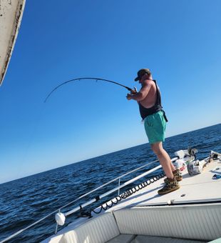 Focused angler battling deep-sea catch