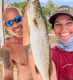 Captain Hara with cousin James holding a slot Speckled Trout 