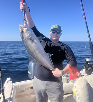 Reeling in a big one out on the open water.