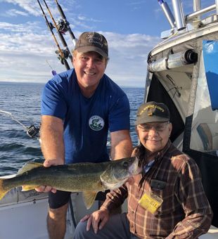 Angler proudly holds a big walleye  caught on Lake Erie, Pennsylvania.