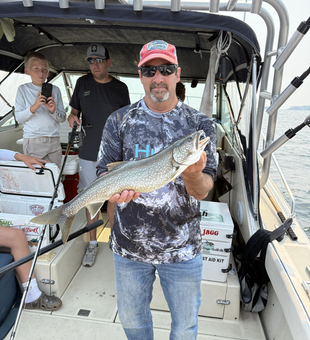 Reeling in a big lake trout while trolling at Knife River Marina!