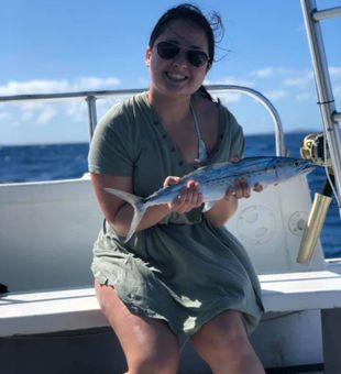 Smiling with a fresh Spanish mackerel.