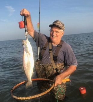 Happy catch of a hefty Speckled Trout