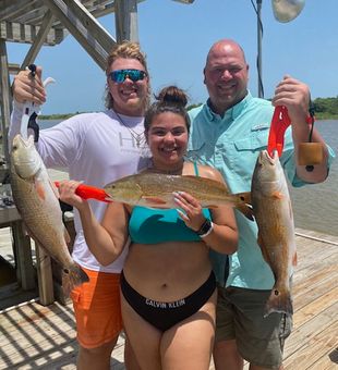 Smiling crew with solid Redfish catch
