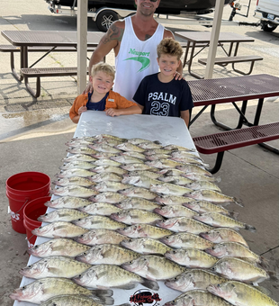 Huge white crappie doubles up on a partly cloudy day!