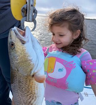 Family fun on the water in Hopedale—kids love reeling in their first redfish while enjoying calm, easy inshore fishing conditions. 