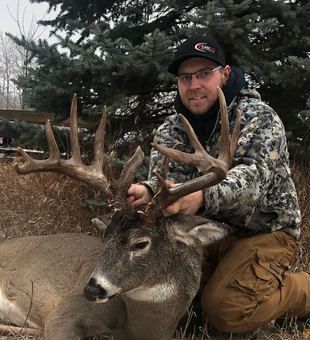 Massive whitetail buck, proud harvest.