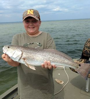 Redfish Fishing: Big catch, Big smile.