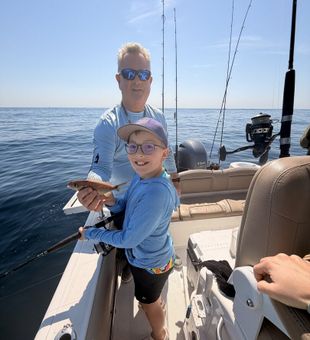 Proud young angler with redfish on a family fishing charter
