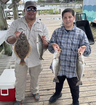 Anglers enjoying a productive day on the water, reeling in a variety of summer flounder and spotted weakfish.