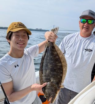 Proud hands on a hefty flounder!