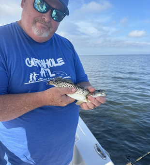 Reeling in the elusive Spotted Weakfish off Manteo's stormy coast!