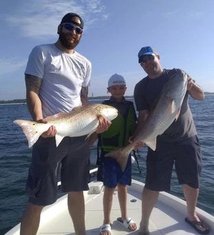 Successful catch of redfish on board.