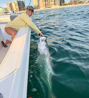 Happy angler with silver tarpon release