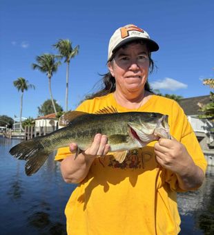 Reeling in trophy largemouth bass while freshwater fishing in Delray Beach, Florida’s urban waterways.