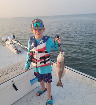 Prime redfish action in Port O’Connor, Texas with perfect inshore conditions.