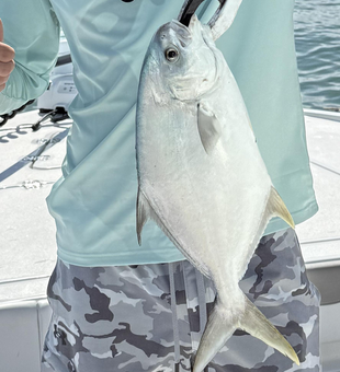 Reeling in a Florida Pompano as clouds gather for afternoon rain!
