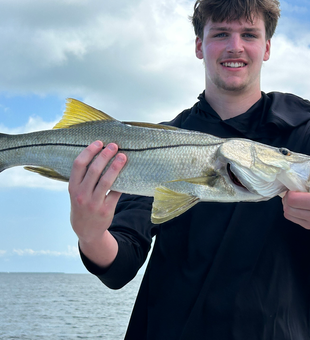 That's one massive Snook reeled in with some tricky tackle!