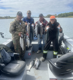 Reeling in the rainbow and chinook combo under partly cloudy skies!