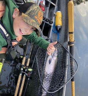 Happy young angler with a fresh steelhead catch!