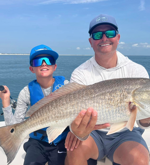 Redfish trophy catch for young angler.