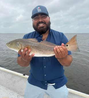 Happy angler with a big redfish.