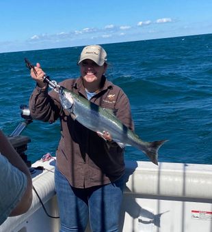Bent rods and smiling anglers after a successful salmon bite on Lake Ontario.