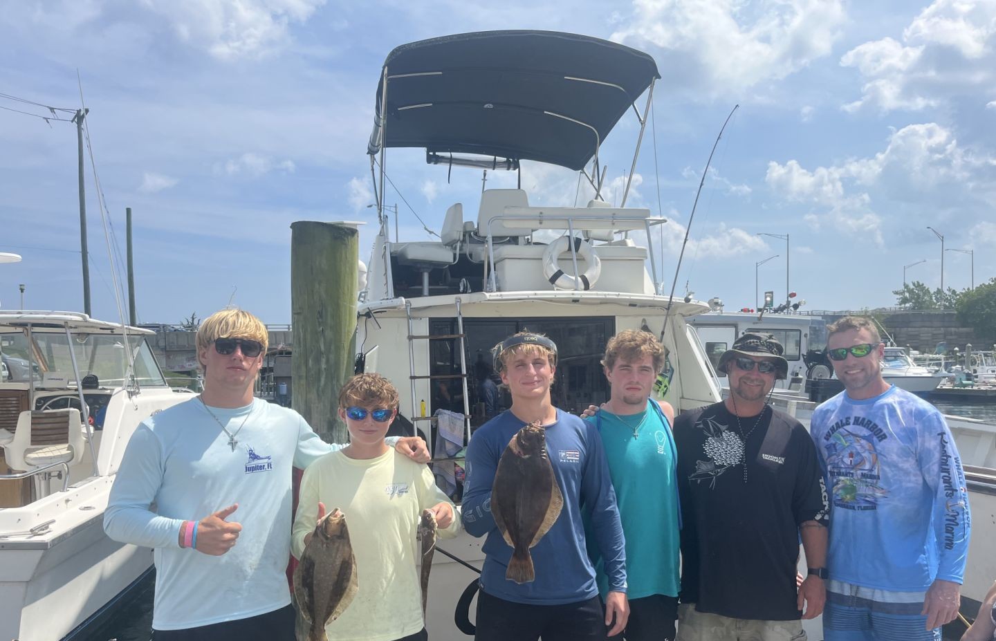 Team showing off fresh Flounder catch at the dock!