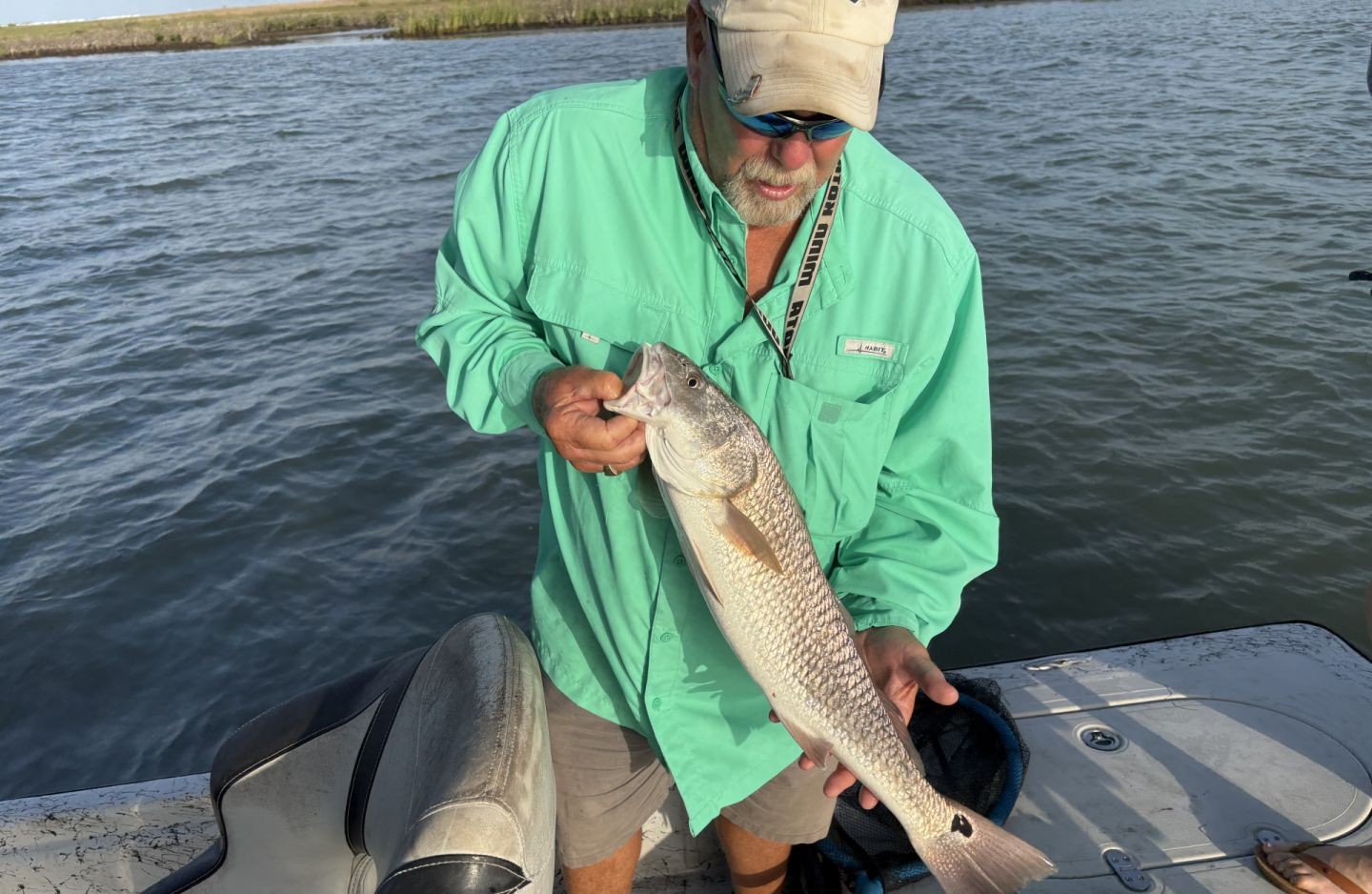 Slot red on the line in Aransas Pass. Texas flats fishing at its finest with strong runs and beautiful copper colors.