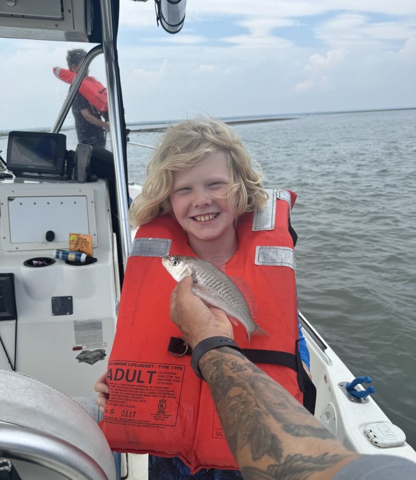 Fun redfish catch on a family fishing trip