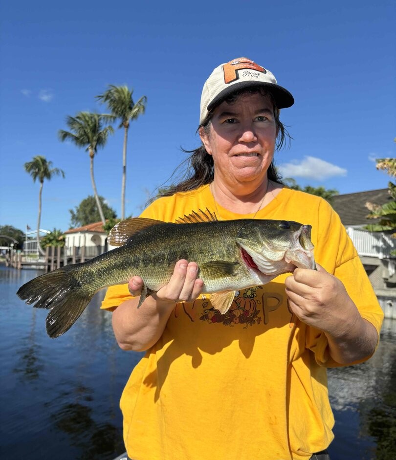 Reeling in trophy largemouth bass while freshwater fishing in Delray Beach, Florida’s urban waterways.