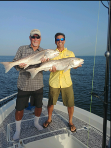 Two anglers fishing in Florida with a large catch