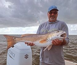 A lone angler reeling in a 28-inch catch in NC