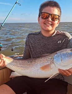 Fisherman with a 16-inch fish in Wanchese