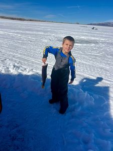 Ice fishing catch held up on frozen lake in Rifle Colorado