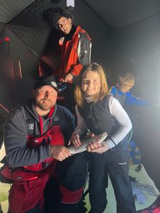 Rainbow trout caught while fishing in Rifle Colorado inside ice fishing shelter