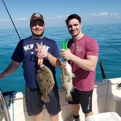 Two gag grouper and summer flounder fish caught while fishing in Florida