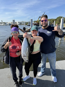 A fisherman holding a 17-inch Blackfin Tuna caught while fishing in FL