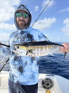 Reeling in a Blackfin Tuna under partly cloudy skies!