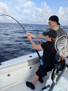 Two people fishing on the shore in FL