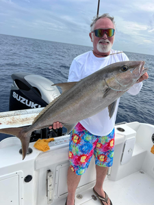 A fisherman holds a large Longfin Yellowtail in Jensen Beach