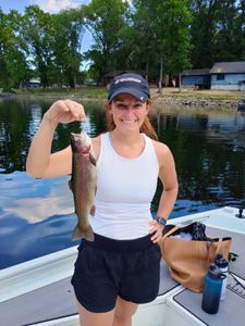 A fisherman holding a rainbow trout in Missouri