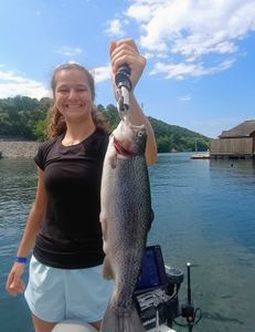 Angler with large rainbow trout caught while fishing in Branson
